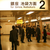 Tokyo salaryman waiting for trains in the subway