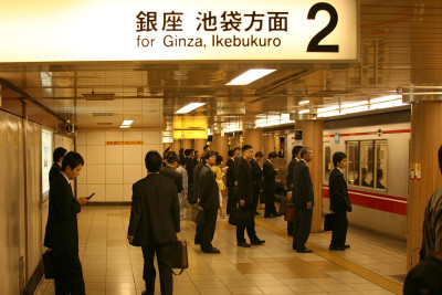 Tokyo salaryman waiting for trains in the subway